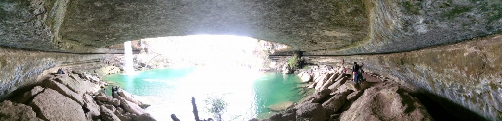 A panoramic photo of Hamilton Pool from inside the grotto.